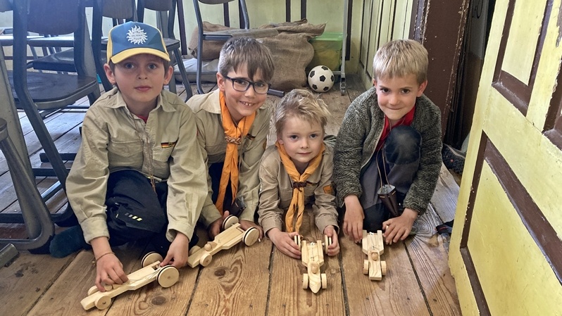 Vier Kinder machen ein Wettrennen mit ihren selbstgebauten Autos.